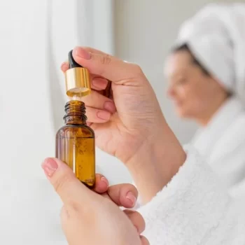 close-up-woman-holding-serum_23-2148709279